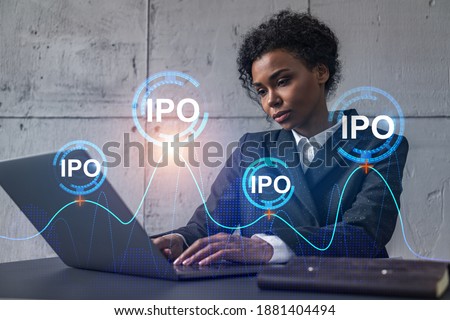 Businesswoman typing on laptop work in modern office on new project. IPO icon drawing hologram. Double exposure. Concept of success.