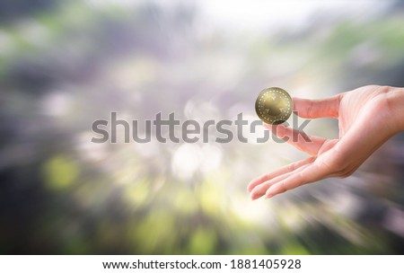 The gold handle in the gold coin investment business that is used for business investment is separated from the color background. Photos to be printed
