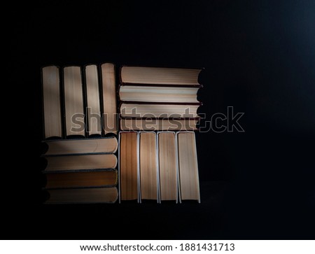 stack of old books on black background