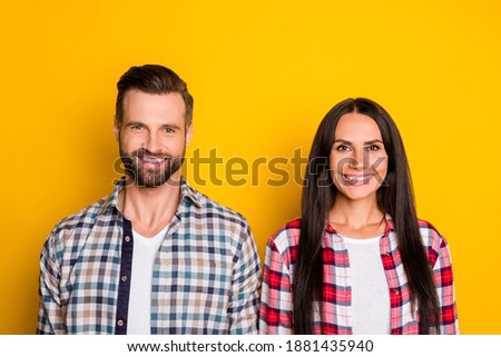 Photo portrait of smiling happy couple isolated on vivid yellow colored background