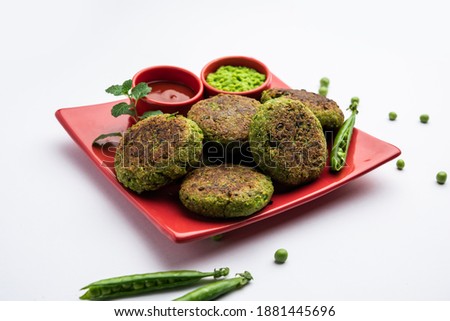 Hara bhara Kabab or Kebab is Indian vegetarian snack recipe served with green mint chutney over moody background. selective focus Royalty-Free Stock Photo #1881445696