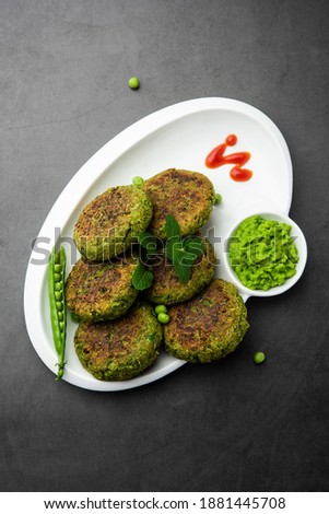 Hara bhara Kabab or Kebab is Indian vegetarian snack recipe served with green mint chutney over moody background. selective focus Royalty-Free Stock Photo #1881445708