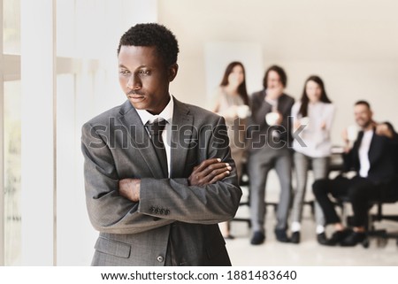 Lonely African-American businessman in office. Stop racism Royalty-Free Stock Photo #1881483640