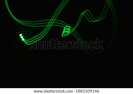 beautiful abstract theme of green spectrum laser light painting evil dark night streaks ray blowing art glowing energy neon long exposure