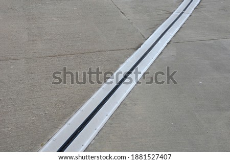 roof structure or bridge expansion for safe connection of two expandable concrete bodies. rubber joint in a metal bar Royalty-Free Stock Photo #1881527407