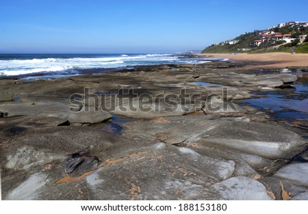 grey flat drying rocks at low tide