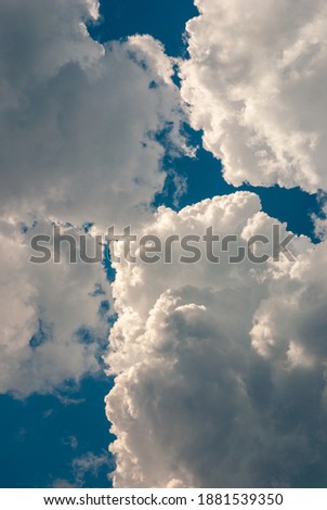 beautiful thunderous clouds in blue sky before thunderstorm, vertical pic