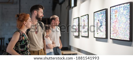 Group of friends in modern art exhibition gallery hall contemplating artwork. Abstract painting Royalty-Free Stock Photo #1881541993