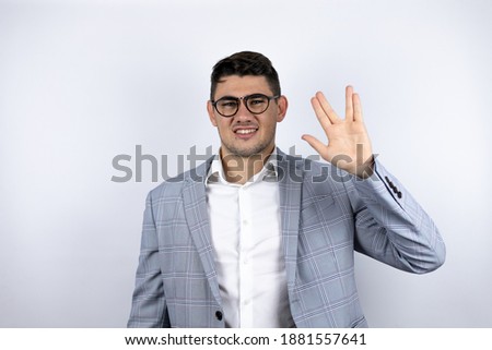 Business young man wearing a casual shirt over white background doing hand symbol