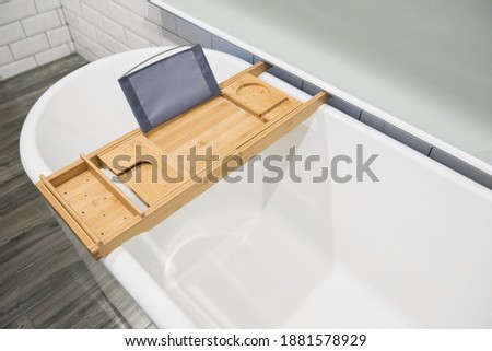Wood bathtub candy try with extandable side holders.  Royalty-Free Stock Photo #1881578929