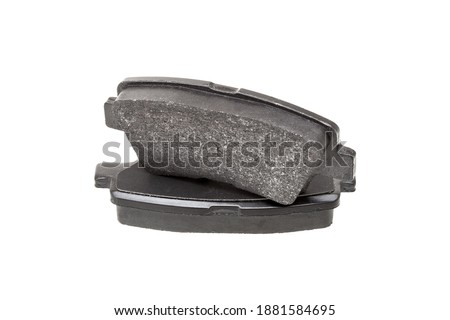 brake pads one on top of the other demonstrate the thickness of asbestos abrasive coating, new car spare parts isolated on white background. Royalty-Free Stock Photo #1881584695