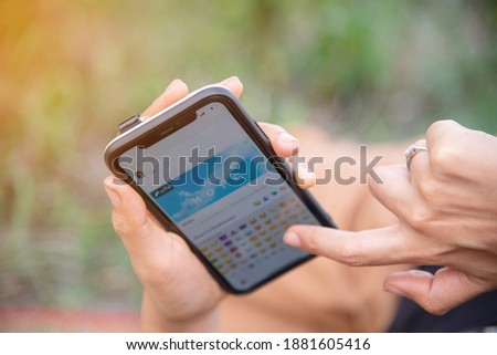 Hands holding a mobile smartphone typing the word hope, chat, post status on social media, hope concept.