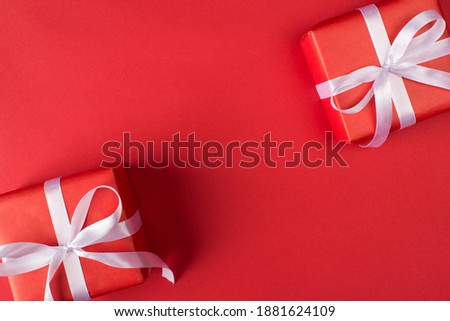 Top layout close up flatlay view photo of two wrapped present boxes with white ribbon and bow isolated bright color background with copy space