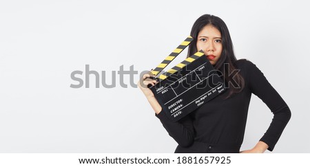 Asian woman is holding black clapper board or Clapperboard or movie slate or clapboard use in video production ,film, movie,cinema industry on white background.