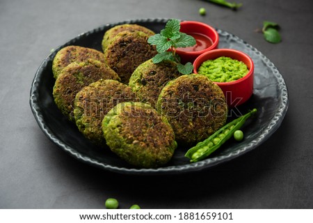 Hara bhara Kabab or Kebab is Indian vegetarian snack recipe served with green mint chutney over moody background. selective focus Royalty-Free Stock Photo #1881659101