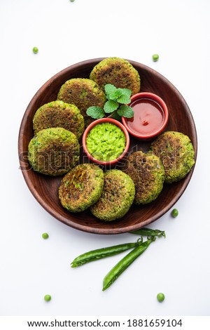 Hara bhara Kabab or Kebab is Indian vegetarian snack recipe served with green mint chutney over moody background. selective focus Royalty-Free Stock Photo #1881659104