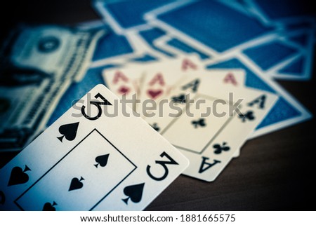 Playing cards are laid out on the table, pictures up and pictures down