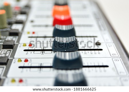 The faders are all open right on the mixing console, close-up.