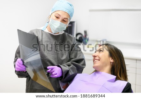 Doctor dentist showing patient's teeth on X-ray. High quality photo