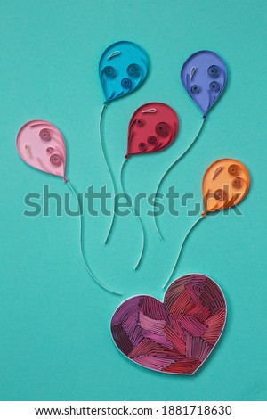 The Heart and colorful balloons on blue background. Party elements. Love is in the air. Hand made of paper quilling technique.