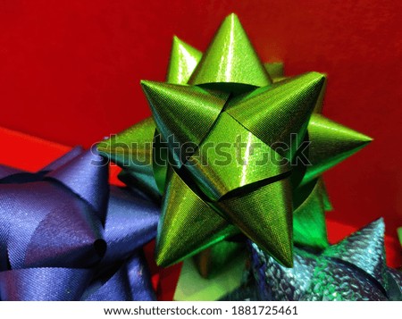 A closeup shot of a decorative gift box's colorful ribbons of different shapes
