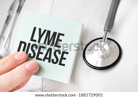 Doctor holding card in hands and pointing the word lyme disease