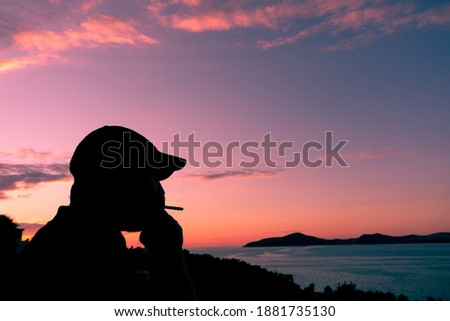 Sporty man smoking against amazing sunset view
