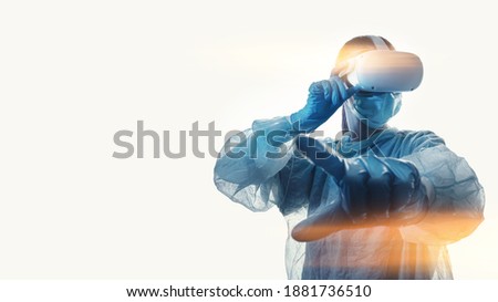 woman doctor in a helmet of virtual reality with manipulators in hands on a white background. the concept of conducting remote operations using modern VR technologies