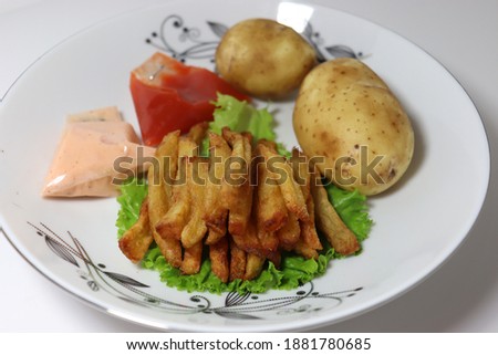 French fries stock with sauce potato Lettuce on plate