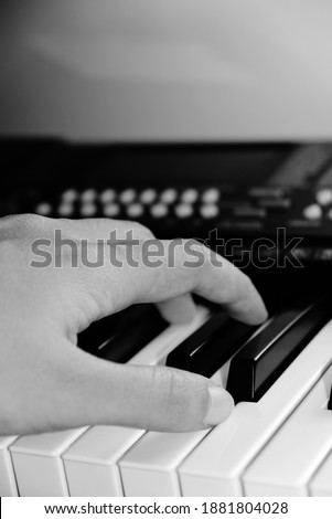 Close up hands on the synthesizer keyboard