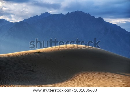 Hill of the chara sands against the background of the Transbaikal ridge Royalty-Free Stock Photo #1881836680