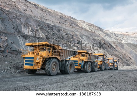 picture of big yellow heavy trucks in open cast mine