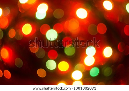 Beautiful festive new year bokeh. Red color blurry lights. Shiny background.
