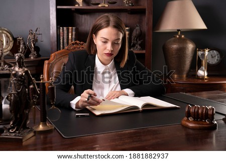 
Young female lawyer checks free appointments. Law concept.