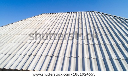 Modern roof. Roof covering. Roman profile. The roof of the house is covered with wavy gray tiles. Royalty-Free Stock Photo #1881924553