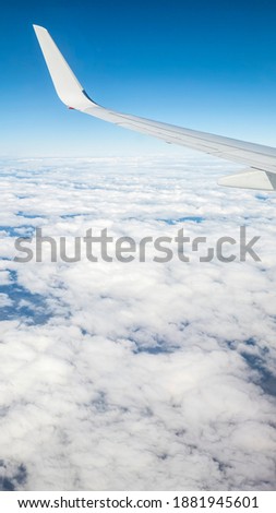 Flying above the sea of clouds. Features bright blue sky and white clouds. Slight curvature of the Earth at the horizon.