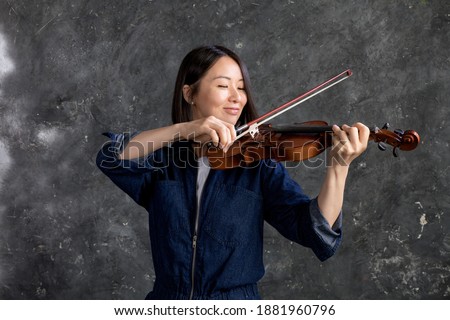 Beautiful korean woman plays violin studio emotional portrait