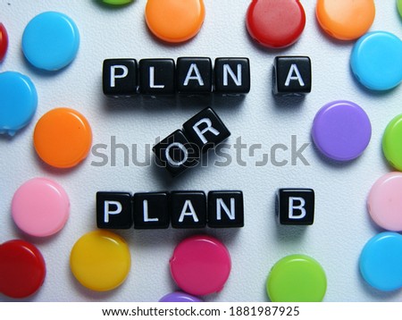 Plan A or Plan B words of square individual letter and colorful round shape buttons on white background. Suitable for illustration or concept 'decision not yet been made' 