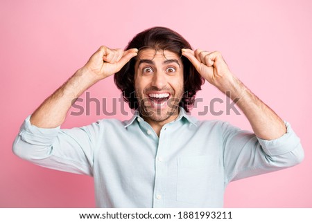 Portrait of cheerful impressed guy arms hold glasses unbelievable news isolated on pastel pink color background