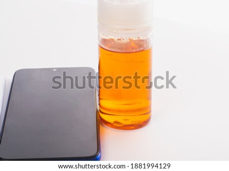Old smartphone jar of glycine and an open notebook, on a white isolated background