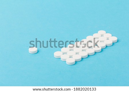 Heap of pills on blue background. pharmacetic concept: pills top view on blue background