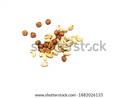 Appetizing hazelnuts, pistachios and cashew nuts on a white background