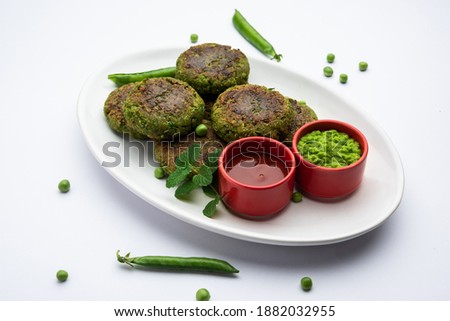 Hara bhara Kabab or Kebab is Indian vegetarian snack recipe served with green mint chutney over moody background. selective focus Royalty-Free Stock Photo #1882032955