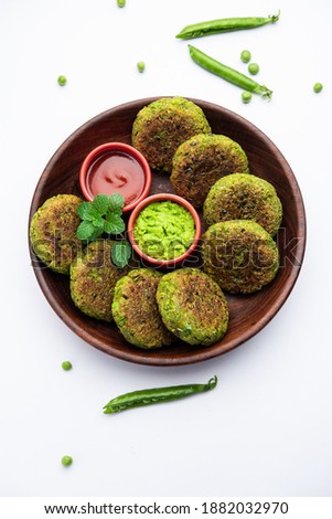 Hara bhara Kabab or Kebab is Indian vegetarian snack recipe served with green mint chutney over moody background. selective focus Royalty-Free Stock Photo #1882032970