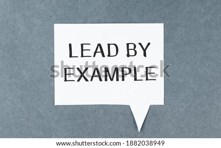 Text lead by example on the short note texture background
