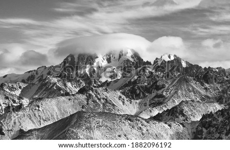 Black and white picture of Talgar peak under clouds in Northern Tien Shan mountains, Kazakhstan
