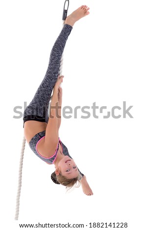 Girl flipping upside down on rope