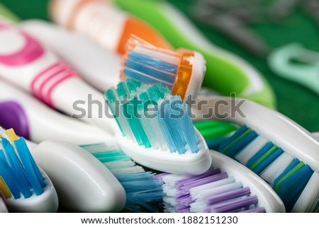 Different multi-colored toothbrushes stock images. Morning hygiene concept. Bathroom accessories images. Toothbrush on a silver background. Toothbrush on a light background with copy space for text.