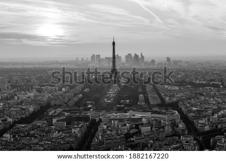 Aerial view of Paris with Eiffel tower and major business district of La Defence in background at sunset.