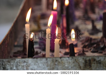 Candles lit in the Church. A group of candles that the faithful put in the Church to pray. Date of capture: 11.17.2020